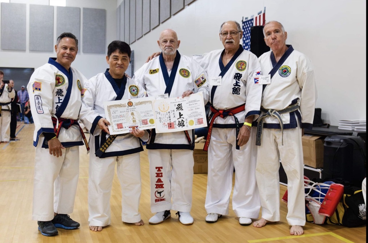 Senior federation masters with Dan certificates at a federation event